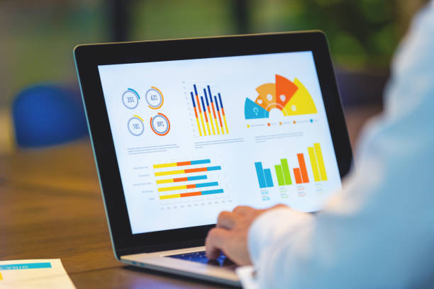 istock Close up of businessman using a laptop with graphs and charts on a laptop computer. 1491361325