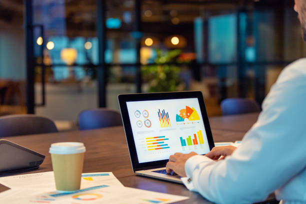 istock Close up of businessman using a laptop with graphs and charts on a laptop computer. 1491361333