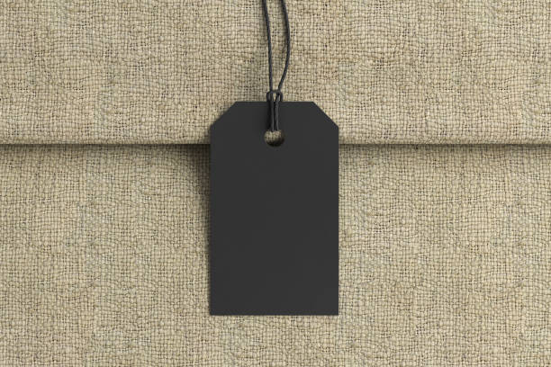 istock Black tag mockup on fabric background. View directly above 1491362351