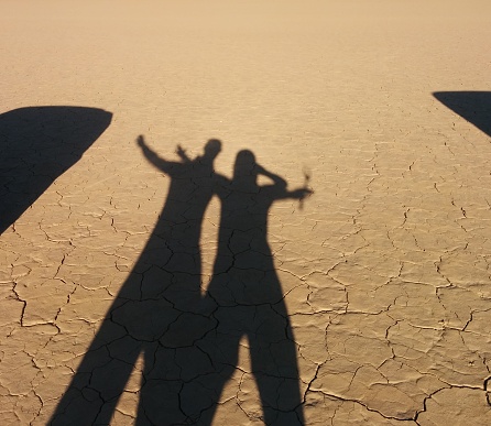 Shadow of people hugging in the desert of Leoncito in San Juan, Argentina.