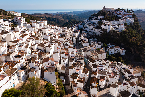 Scenic aerial view of small mountain Spanish village of Casares with Moorish cliff-hugging buildings