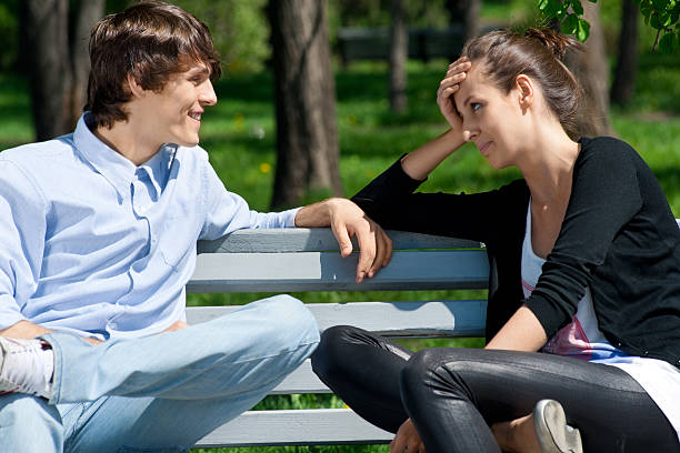 istock Couple sitting together on park bench 149136706