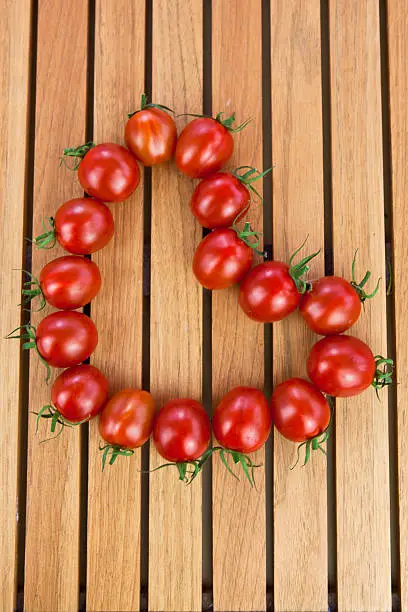 Fresh tomatoes in heart shape .