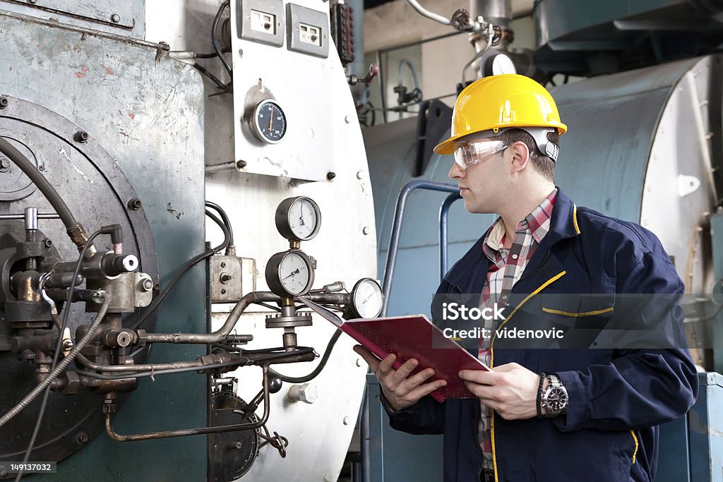 Male engineer at work with clipboard Young engineer inspects the plant. Adult Stock Photo