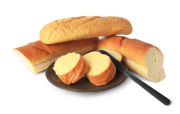 istock Cut baguettes with fresh butter on white background 1491370461