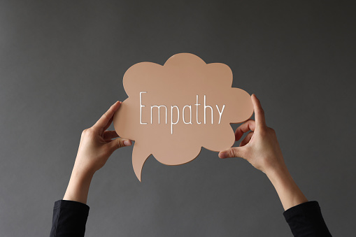 Woman holding speech bubble with Empathy word