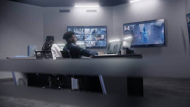 istock Security officers sit in surveillance room 1491371402