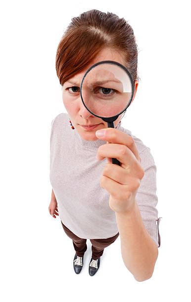 istock Serious woman as detective with magnifier 149137356