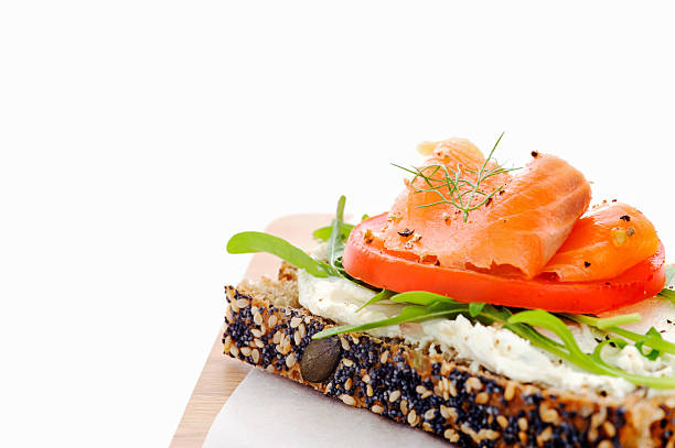 Smoked salmon, salad and a fresh cheese spread on a slice of seeded bread