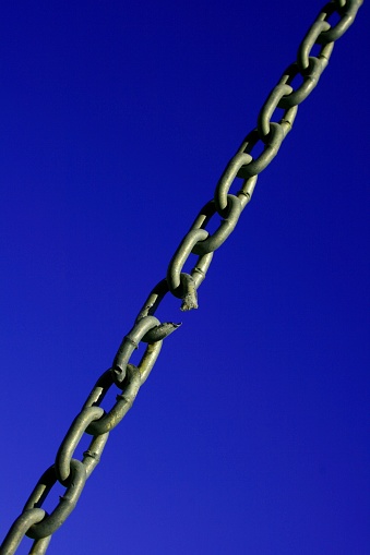 A close up of a damaged chain about to snap under load