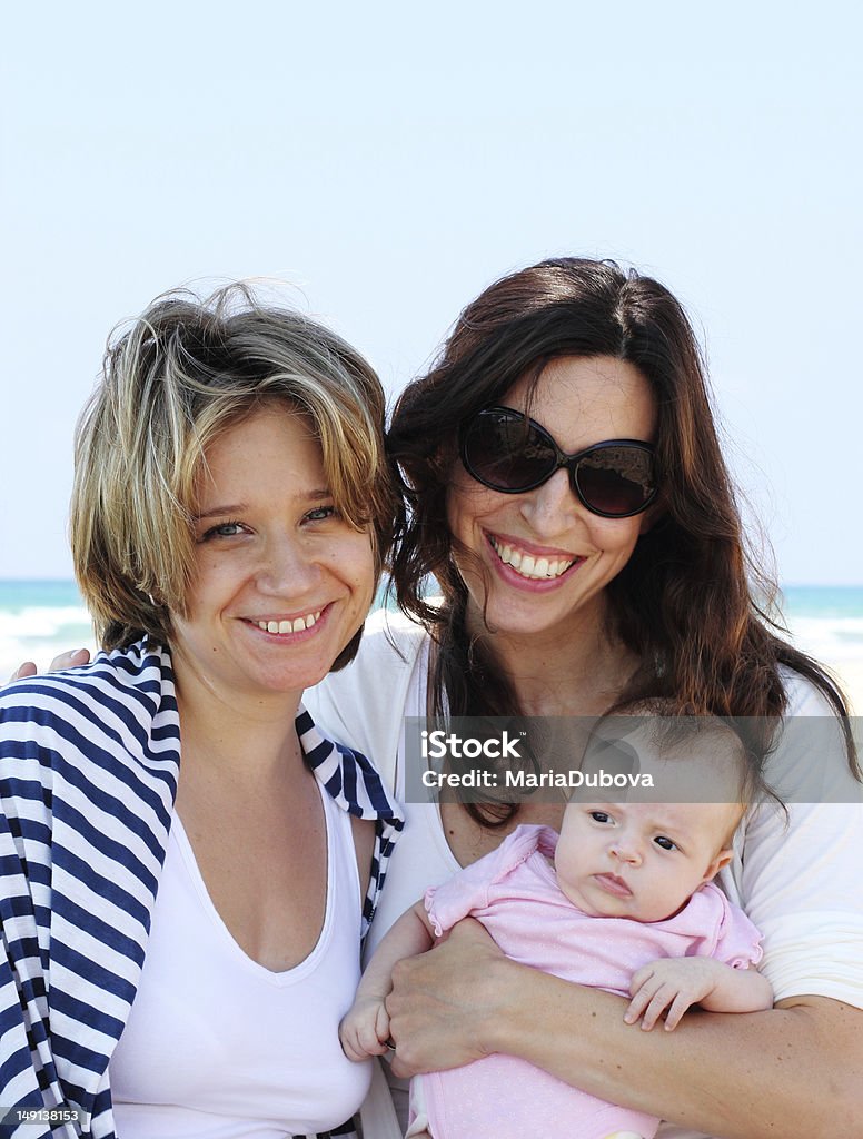 vacation on the beach two beautiful girls with a baby on the beach Activity Stock Photo