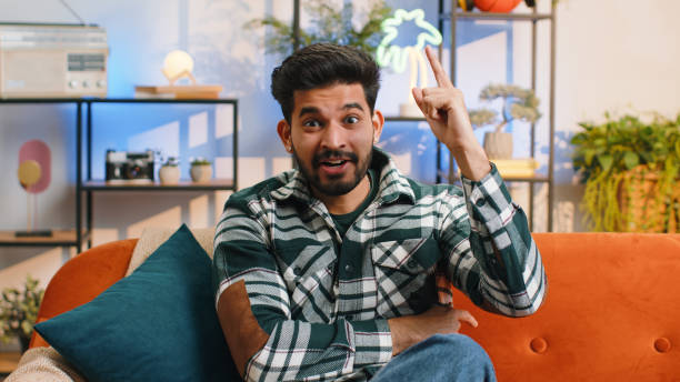 istock Thoughtful inspired indian man make Eureka gesture raises finger came up with creative plan at home 1491389114