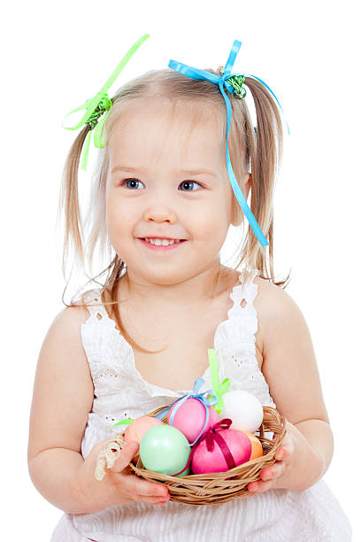 istock cute smiling little girl holding Easter eggs in basket 149139421