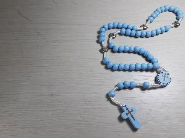 Photo of Blue Rosary on White Table: Serenity and Devotion
