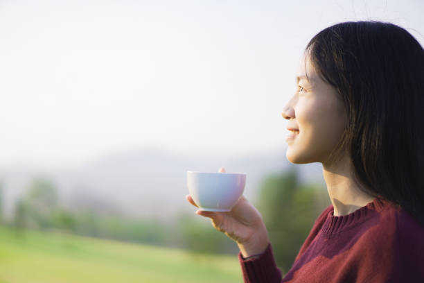 istock Asian young woman drinking a coffee. 1491397324