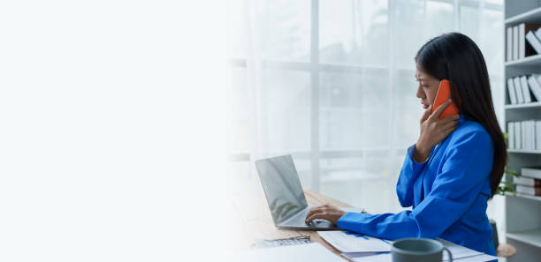 istock Busy businesswoman wearing a suit busy with work workaholic while sitting at work clear paperworks with documents and talk on the phone on your smartphone hear the hustle and bustle, busy concepts. 1491401177