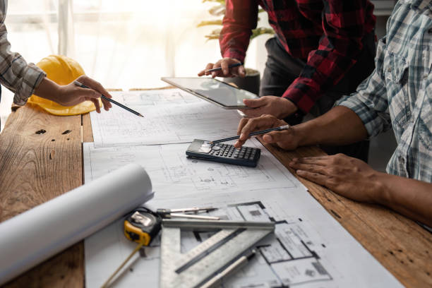 istock team engineer checks construction blueprints on new project with engineering tools at desk in office 1491404528
