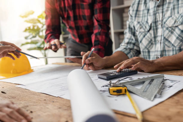 istock engineer working in office with blueprints, inspection in workplace for architectural plan, construction project ,Business construction 1491404533