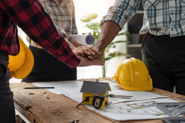 istock construction team handshake greeting start new project contract plan in office center at construction site partner and contractor yellow hard hat on table and house design print design 1491404632