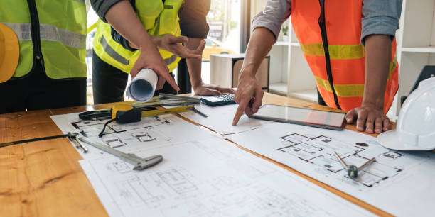 istock engineer people meeting working and pointing at a blueprint in office for discussing. Engineering tools and construction concept 1491404896