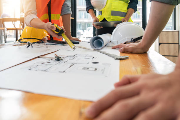 istock engineer people meeting working and pointing at a blueprint in office for discussing. Engineering tools and construction concept 1491405036