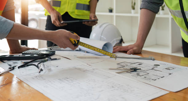 istock engineer people meeting working and pointing at a blueprint in office for discussing. Engineering tools and construction concept 1491405054