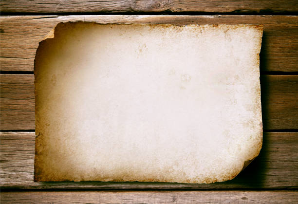 istock old paper on the wooden wall background. 1491406100