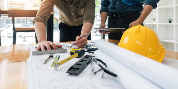 istock engineer working in office with blueprints, inspection in workplace for architectural plan, construction project ,Business construction 1491406287