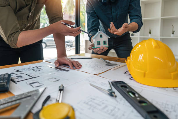 Construction concept of meeting engineers or architects for projects working with partners and engineering tools on modeling and blueprint design in office