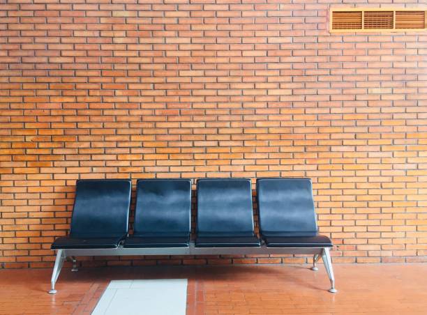 istock empty chairs, waiting chairs with a background of brown bricks. 1491410689