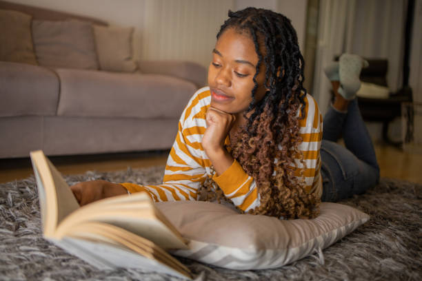 istock Woman relaxing and reading a book 1491411028
