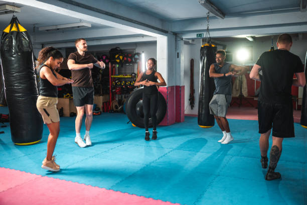 istock Handsome Multiracial Friends Training With A Boxing Coach 1491412883