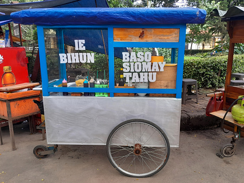 Bandung, West Java, Indonesia - May 18, 2023. An Indonesian street food cart typically found at the side of the street selling instantly cooked food. This one offers various kinds of noodle and bihun as well as Baso meatballs, siomay and tofu.