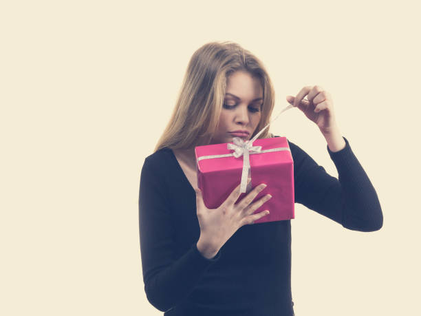 istock Girl opening pink gift box 1491415541