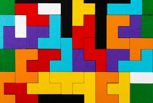 Background of different colorful shapes wooden blocks.