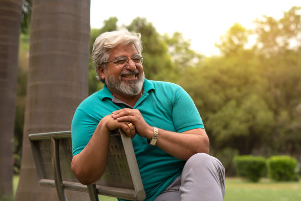 istock Senior citizen male sitting on bench in park 1491423863