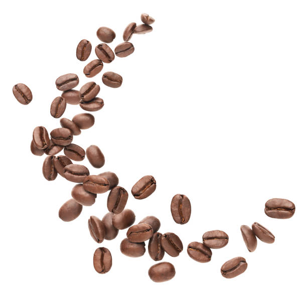 Coffee beans splashing Coffee beans splashing over white background roasted coffee bean stock pictures, royalty-free photos & images