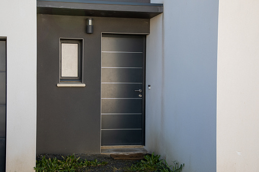 grey door modern house entrance with contemporary white gray facade