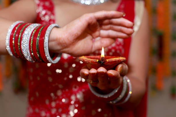 istock Unrecognizable women holding oil lamp in hand 1491429267