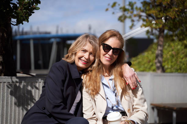 istock Two women smiling while posing together outdoors. 1491429522