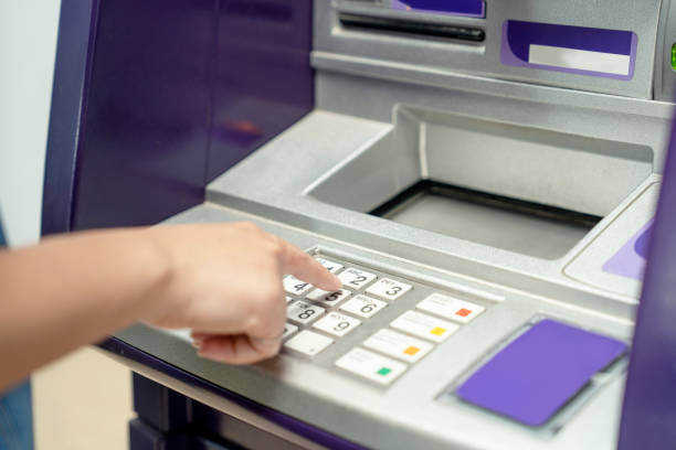 istock Closeup of hand entering PIN code into an ATM bank machine. 1491430189