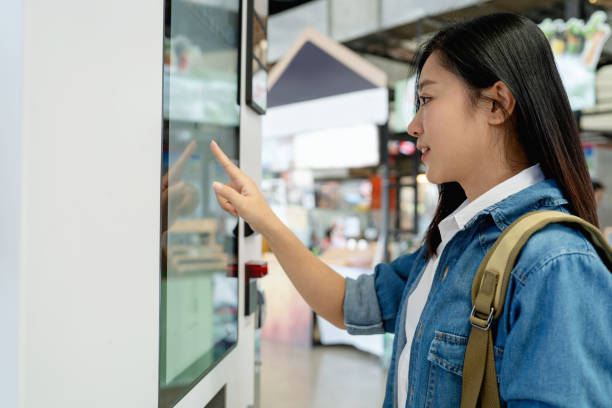 istock Asian woman buying coffee from a vending machine 1491430697