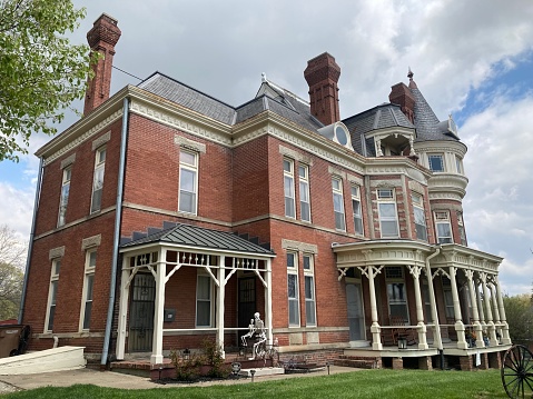 Carthage, MO, 2022: The T. Davey House was designed in the Queen Anne style and features a domed turret, stained-glass windows and chimneys with decorative caps.