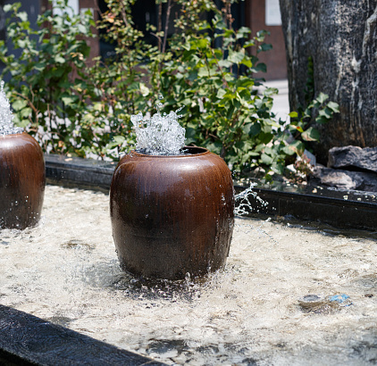 Filling water in a clay pot in summer during lack of water in rural areas and water is overflowing