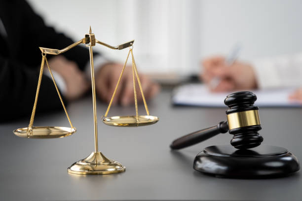 Focus shiny golden scale balance on blur background. Equilibrium Focus shiny golden balanced scale on blurred background of lawyer working on desk at law firm office. Gavel hammer for righteous and equality judgment by lawmaker and attorney. Equilibrium law library stock pictures, royalty-free photos & images