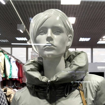 Woman mannequin in jacket close-up blurred background