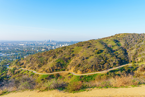 Urban landscape: Hiking trail and Los Angeles view seen from the vista point in the Runyon Canyon Park, California.