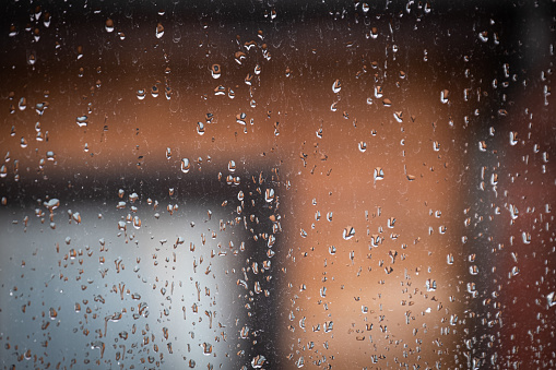 raindrops and water spots on the window glass. blurred background.