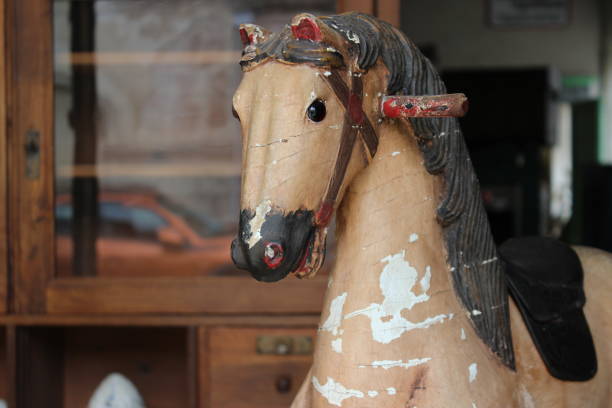 istock Old rocking horse face with blurred background 1491447097