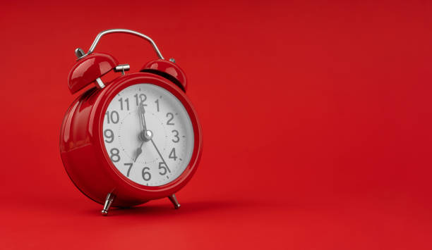 istock Red alarm clock on a red background. 1491450602